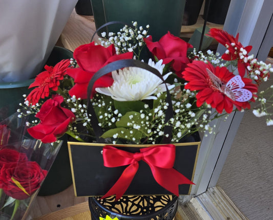 floral arrangement gerberas, roses and spider